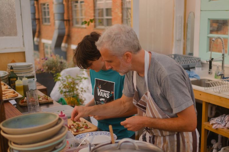 Josh Talmud preparing a salad during supper club on Queensrollahouse roof terrace